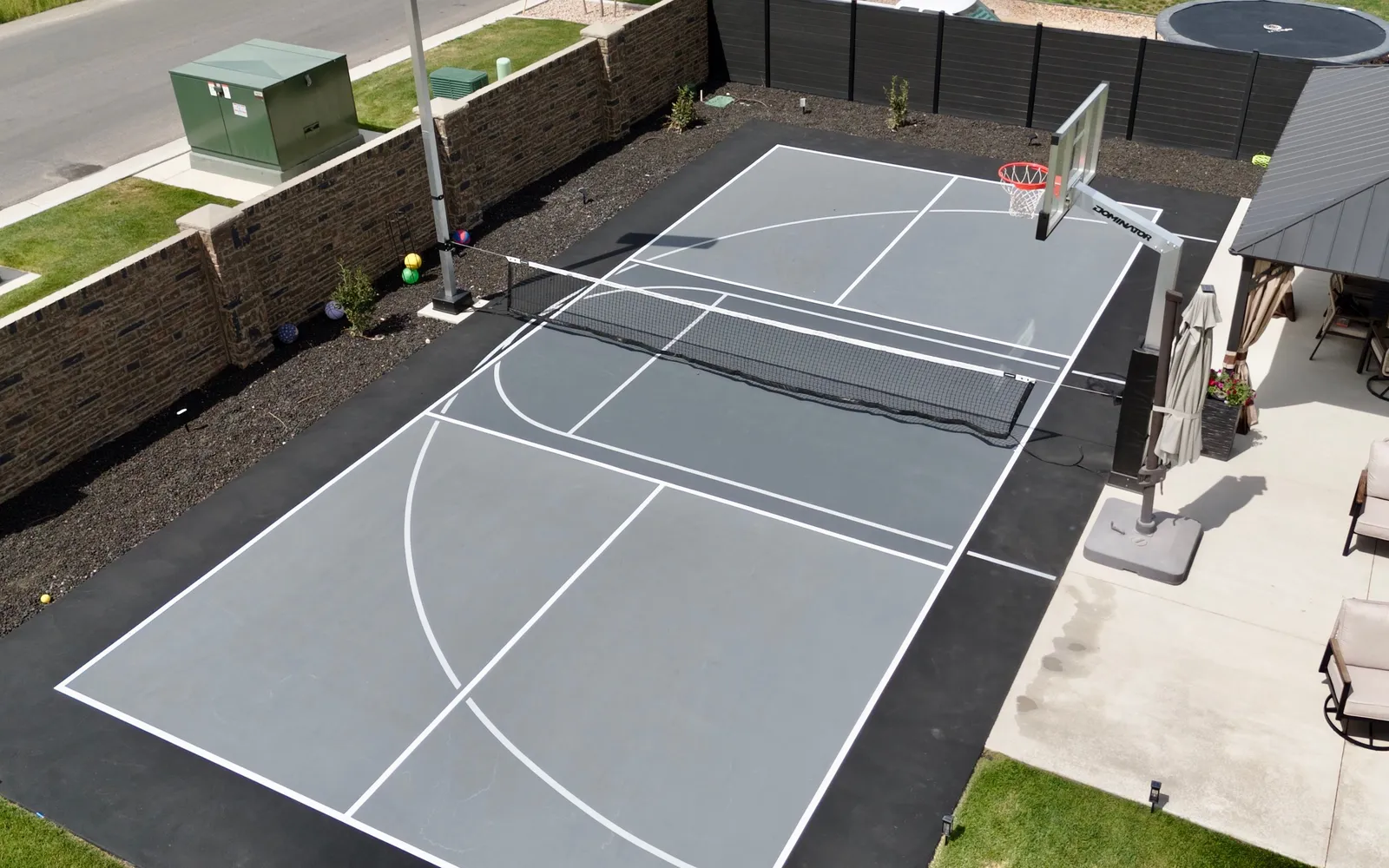 Aerial view of a backyard athletic court on a long, narrow lot