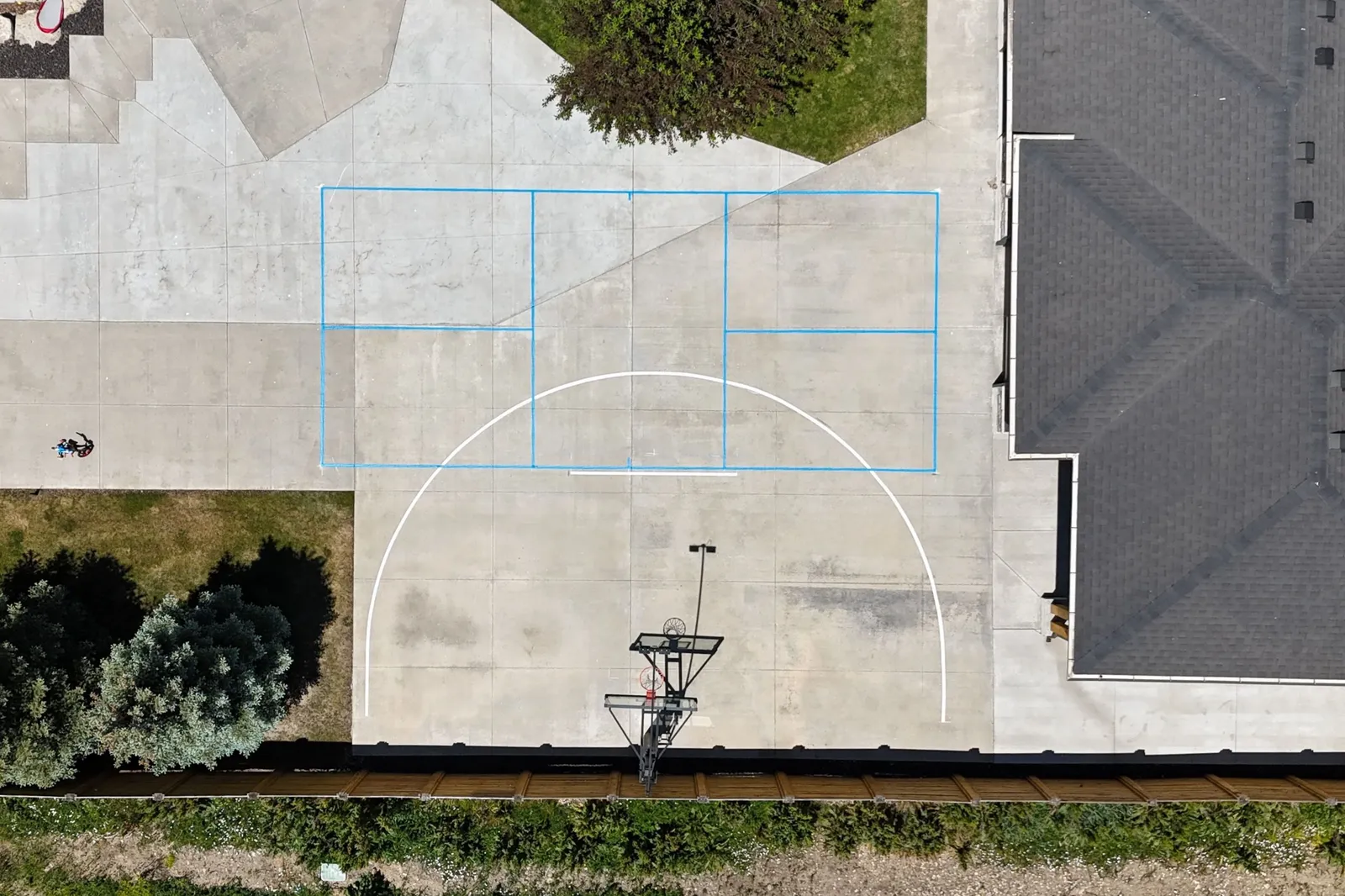 Aerial view of multi-sport court lines on a concrete pad